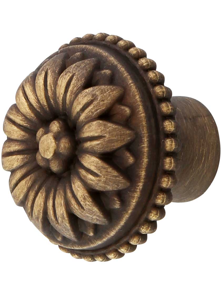 Curved Flower Petal Knob - 1 1/8-Inch Diameter in Antique Brass.